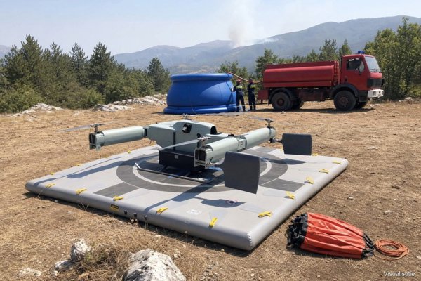 Firefighting drone on the inflatable landing pad beside the reservoir